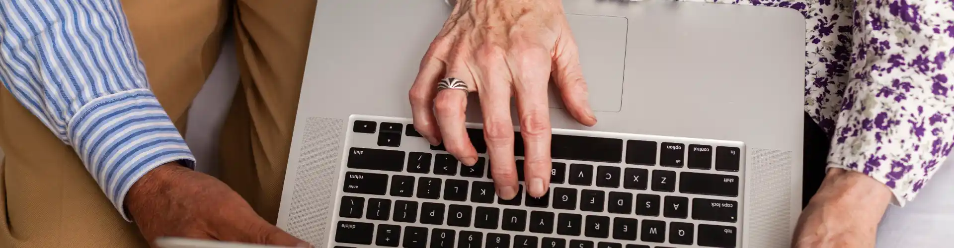 Senior patient using an online prescription service with help from a carer during a telehealth consultation in Australia